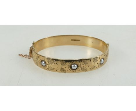 9ct gold decorated bangle set with seed pearls, 34 grams.