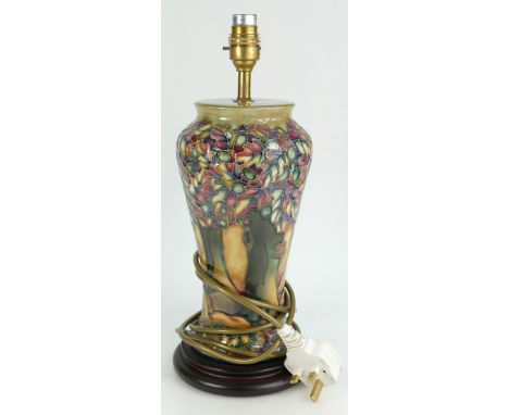 Moorcroft tall Lamp base decorated with trees in woodland design, height 29cm on wooden plinth.