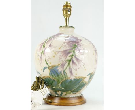 Cobridge Stoneware lamp base hand painted with purple flowers, height 26cm on wooden plinth.