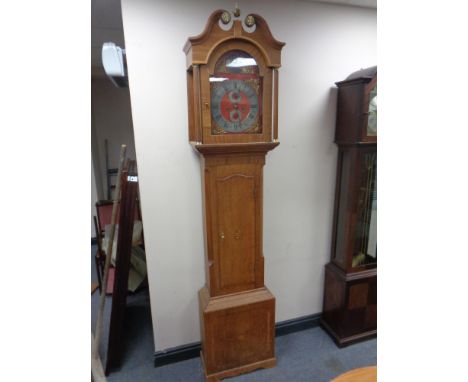 A continental oak longcase clock with brass and silver dial signed Christian Wiuvel with pendulum and weights