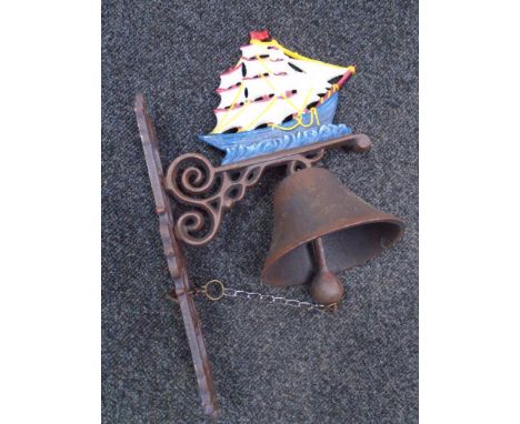 A cast iron tall ship wall bracket with bell.