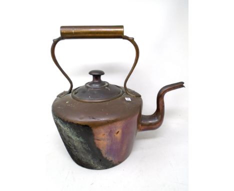 A Victorian copper kettle.