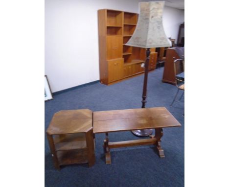 A 20th century three tier book table together with a refectory coffee table and standard lamp with shade 
