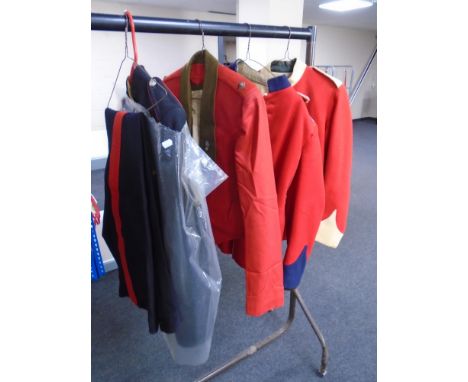 Four 20th century British Army formal tunics together with waistcoat and two pairs of trousers 