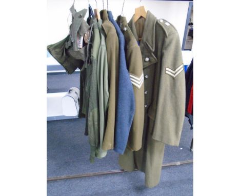 Three 20th century British Army and Air force tunics together with a woolen great coat, army shirt, jumper and first aid kit 