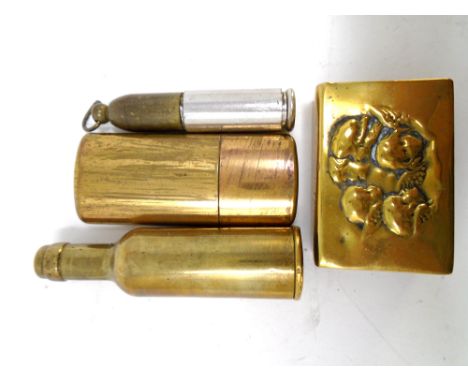 A vintage brass cased lighter in the form of a bottle together with a brass matchbox holder and two further storage pots, one