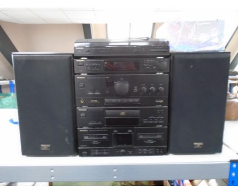 A Technics five piece HiFi separates system with speaker and box of leads.