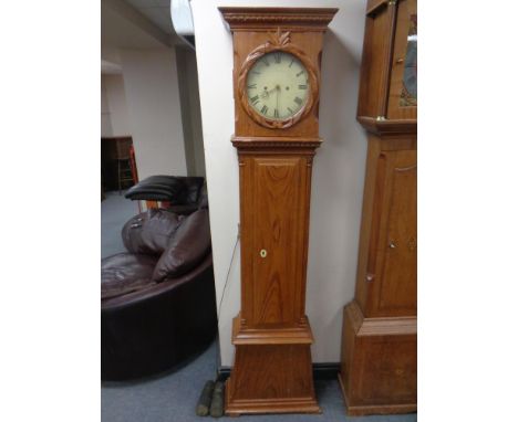 A continental pine longcase clock with painted dial, pendulum and weights