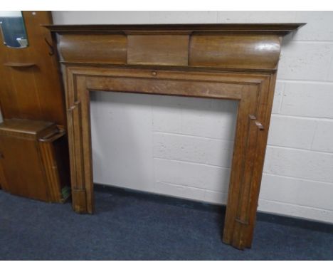 An Edwardian oak fire surround.