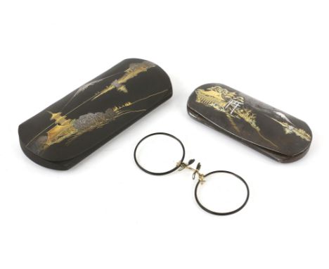 Two Japanese spectacle cases overlaid in yellow and white metals with scenes of Mount Fuji, one with glasses, 11cm and 14cm w