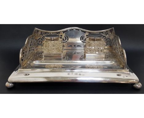 EDWARD VII SILVER DESK STANDwith a shaped and pierced three quarter gallery, with two glass hobnail inkwells with silver lids