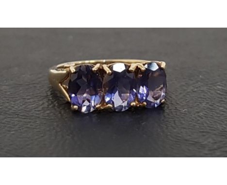 TANZANITE AND DIAMOND RINGthe three oval cut tanzanites in pierced setting with diamonds to the sides, on nine carat gold sha