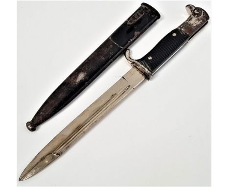 WWII GERMAN BAYONETwith a 19.5cm long blade marked Anton Wingen JR Solingen, with a chequered grip and working button, in a b