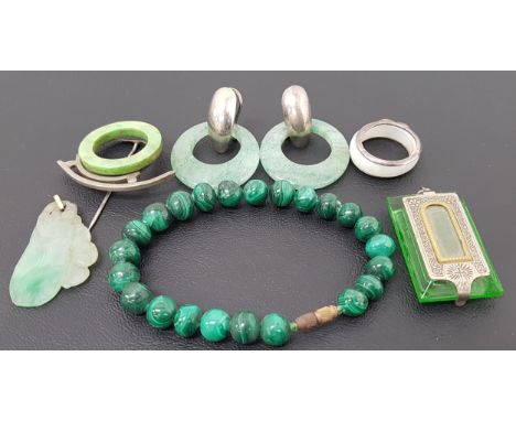 SELECTION OF JADE AND OTHER JEWELLERYcomprising a carved jade pendant in the form of fruit and foliage; a green glass religio