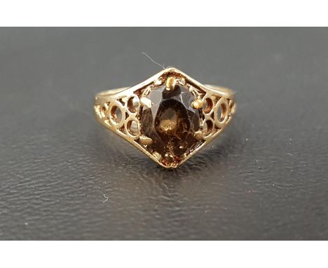 SMOKY QUARTZ SINGLE STONE RINGthe oval cut quartz flanked by decorative pierced shoulders, on nine carat gold shank, ring siz