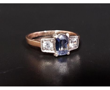 BLUE AND WHITE SAPPHIRE THREE STONE RING the central blue sapphire flanked by a round cut white sapphire to each side, on unm