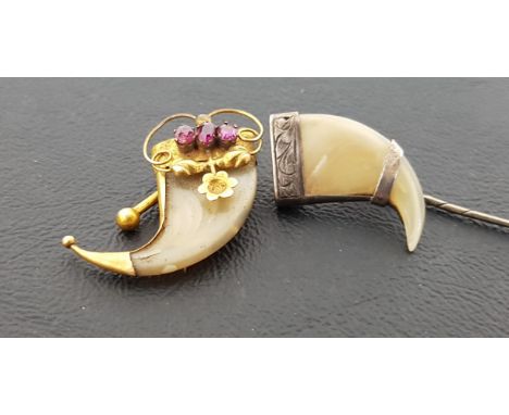 VICTORIAN TIGER CLAW BROOCHthe unmarked gold mounts set with three garnets, maximum length approximately 3.3cm; together with