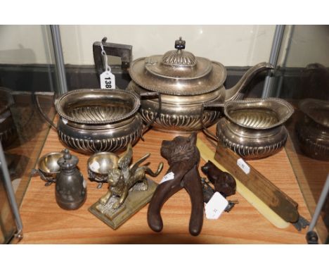 Three-piece EPNS tea service, a pair of EPNS salts, pewter pepper pot with coronet lid, Black Forest pair of nut g]crackers, 