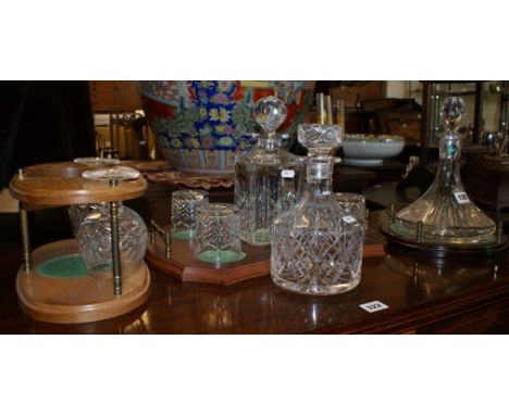 Edinburgh crystal ship's decanter on mahogany stand, a whisky decanter and four glasses on a mahogany stand, one other decant
