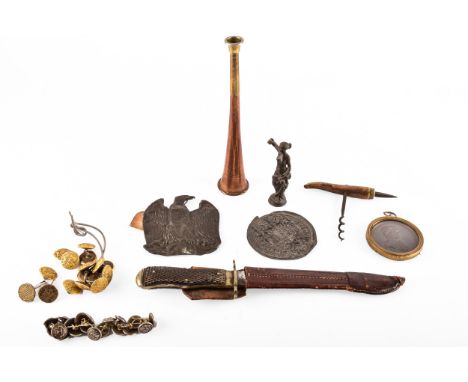 A small collection of militaria including a bronze eagle with handwritten note 'Eagle taken from a French soldier at Waterloo