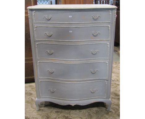 A cream and blue painted bedroom chest, the serpentine front fitted with five long graduated drawers with cast foliate handle