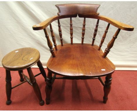 A Windsor stool with dished elm seat on turned supports, together with a Windsor captain's chair with turned spindle moulding