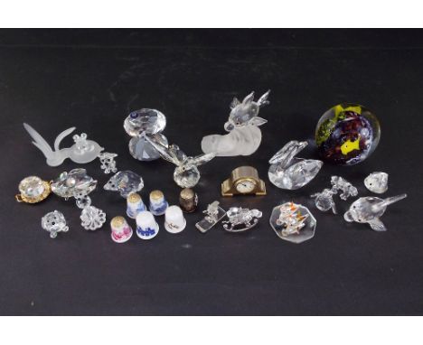 A collection of mainly Swarovski crystal animals together with a small quantity of thimbles, a miniature mantle clock and pap