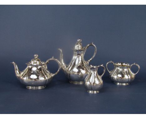 Good quality Victorian four piece tea service of lobed baluster form, engraved with scrolled foliage comprising tea pot, wate