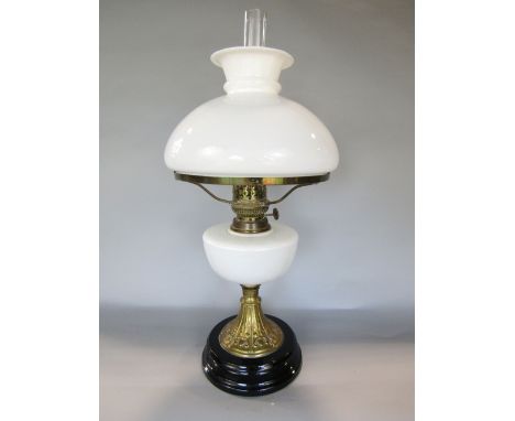 A good late 19th century brass and opaline glass oil lamp with opaline glass shade and reservoir, the tapered brass column em