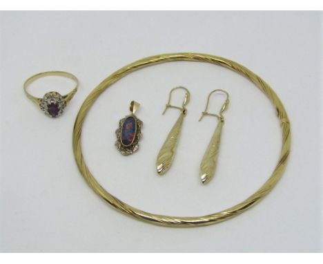 Group of gold jewellery comprising a 10k oval opal pendant with applied foliate border decoration, a bangle of twisted design