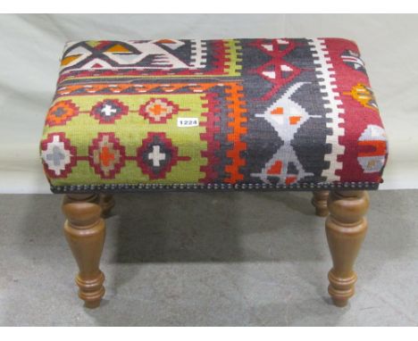 A good quality contemporary Victorian style stool, with Kelim covered rectangular seat raised on four turned tapered legs