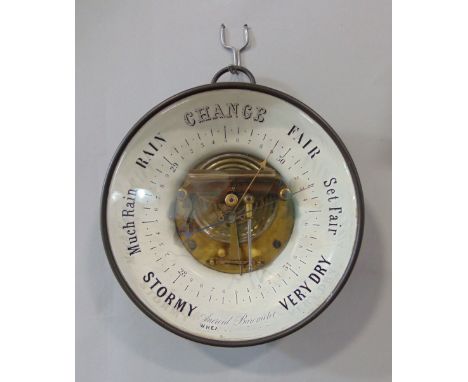 Glazed aneroid barometer with open workings and inscribed glass front, 20cm diameter