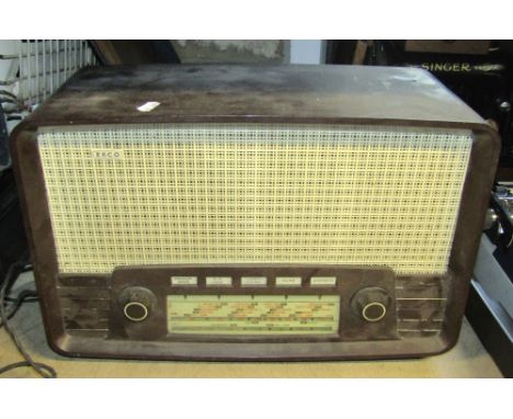 A vintage cased portable Singer sewing machine, together with an Ekco Bakelite cased mains radio model U199 and a further cas