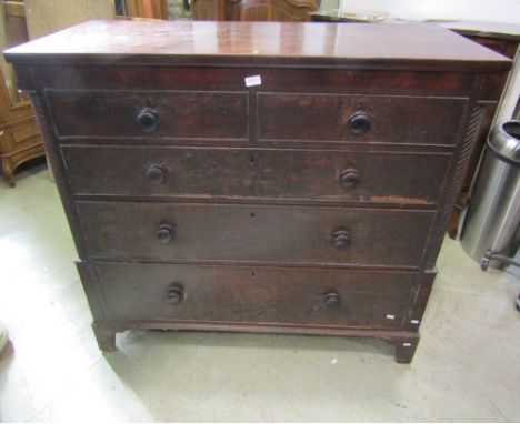 A 19th century oak bedroom chest of two short over three long graduated drawers, partially flanked by split moulded wrythen t