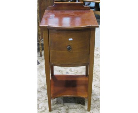 An inlaid Edwardian mahogany bow fronted bedside cupboard or lamp table with boxwood stringing, enclosed by a single door, ra