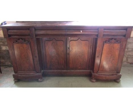 A Victorian mahogany shallow inverted breakfront four door sideboard with well matched flame veneers and three frieze drawers