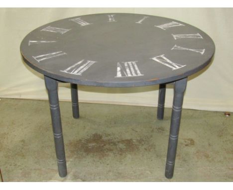 A contemporary pine kitchen table of circular form with painted finish, the top in the form of a clock dial with Roman numera