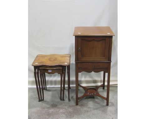 A 19th century mahogany bedside cupboard enclosed by a panelled door over a drawer on square cut supports, united by a shaped