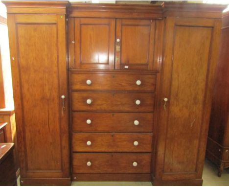 A Victorian pine shallow inverted breakfront triple compactum wardrobe, the central section fitted with five long graduated d