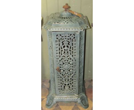 A Victorian cast iron and enamel floor standing conservatory heater of square cut and canted form, with decorative pierced fo