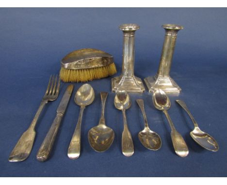 A mixed collection of silver comprising a pair of early 20th century silver candlesticks, six various silver spoons, provinci