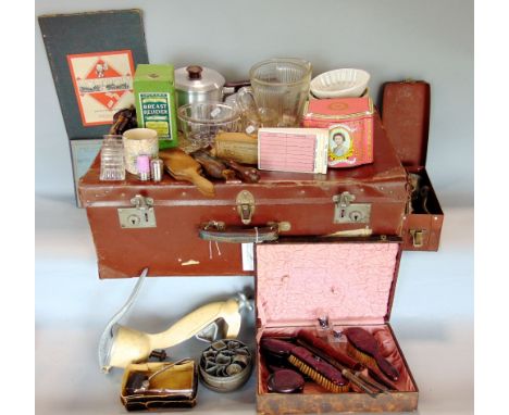 A studded leather trunk containing a collection of kitchenalia to include moulds, mincers, ice buckets, etc