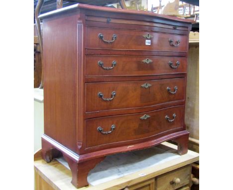 A reproduction Georgian style mahogany veneered serpentine chest of four long graduated drawers beneath a brushing slide rais