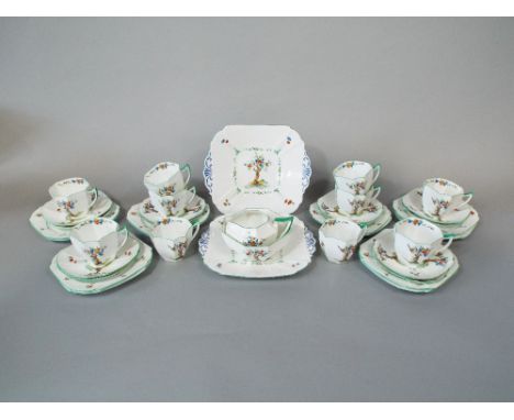 A collection of Shelley Art Deco tea wares, with fruiting tree decoration, comprising a pair of cake plates, milk jug, sugar 