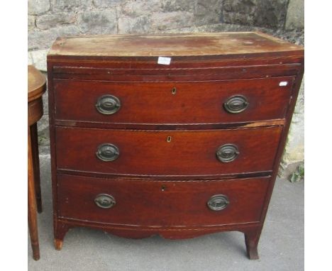 A small Georgian bow fronted caddy top bedroom chest with broad satinwood crossbanding over a brushing slide and three gradua
