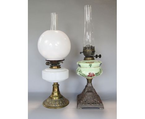 An early 20th century brass and opaline glass oil lamp with glass  globular shade and reservoir, 44 cm high including shade t
