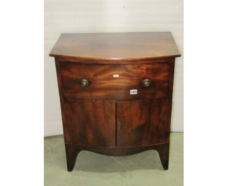 A small good quality side cupboard in the Georgian style with brushing slide over a frieze drawer and cupboard, flanked by ca