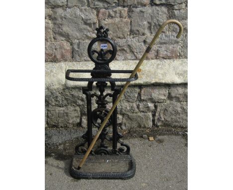 A Victorian cast iron umbrella/stickstand, the decorative raised pierced back, with trailing floral and bird detail (af) toge