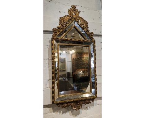 WALL MIRROR, 78cm H x 34cm W, of compact proportions 20th century, giltwood with an arched top and cushion frame. 