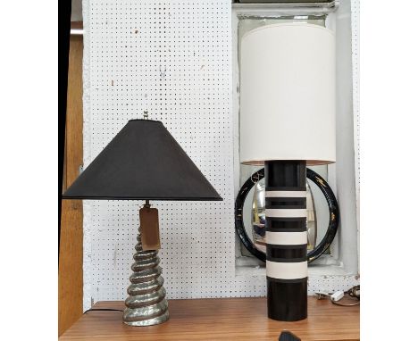 TABLE LAMPS, one lamp with a silver ipilated spiral tapered body, black shade, the other with a black and white body, cream s